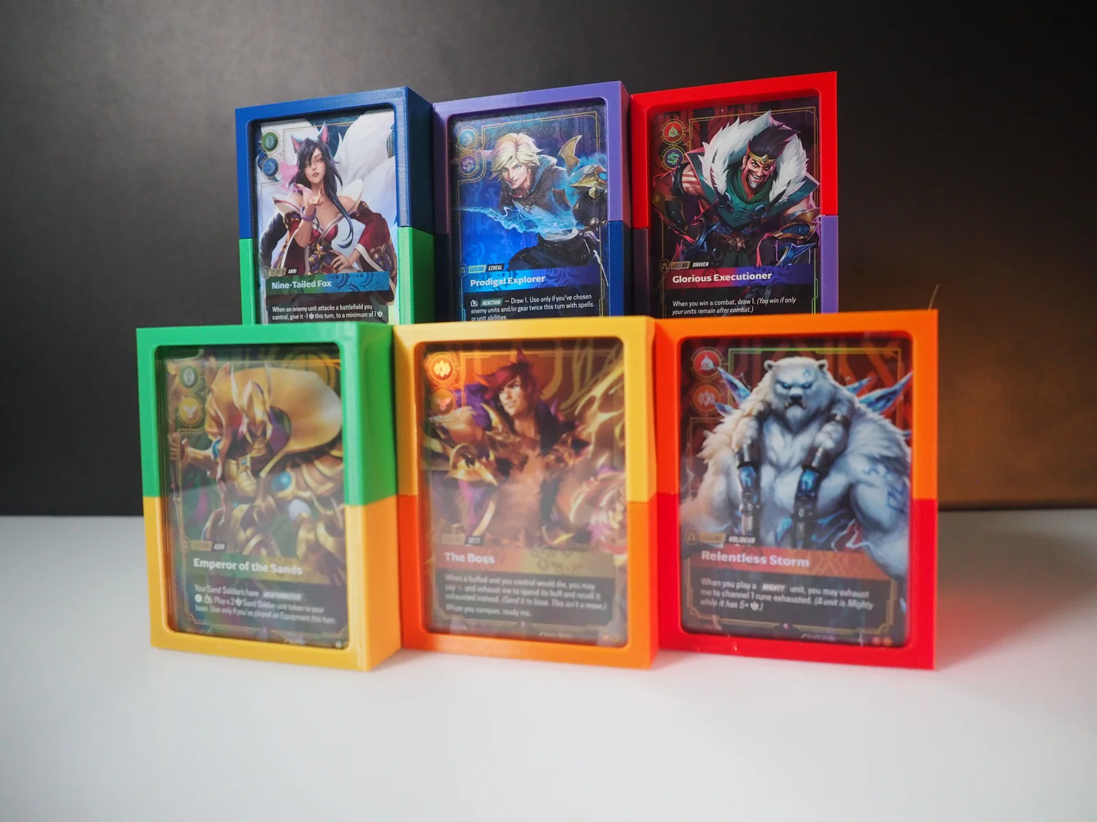 Riftbound deckboxes with displayed Legend cards in several colors